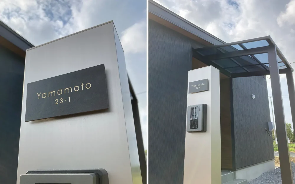 シルバーの機能門柱にブラウンのタイル表札を付けている家。